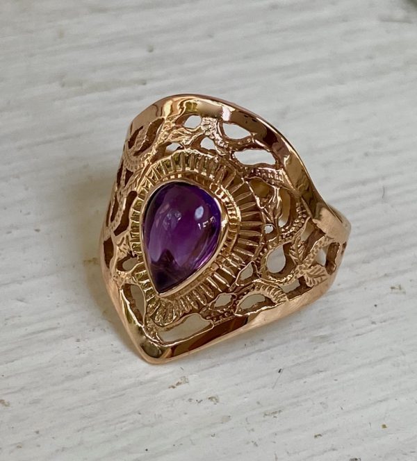 14K rose gold “Persia” with amethyst. Hand-engraved and pierced and set with a 8 x 6 mm pear-shaped cabochon amethyst. Width of ring 20.75mm. Ring size 6.5. $510.